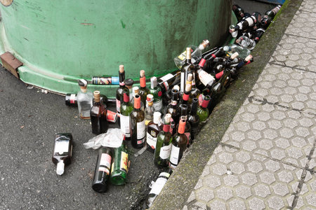 Galicia, Spain; march 8 2019: Lots of empty glass bottles near a glass container. Recycling conceptのeditorial素材