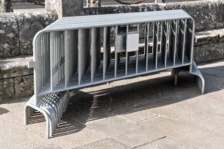 Many movable metal fences stacked on public square with paving stone. Restriction zone concept