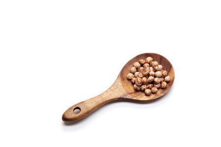 Heap of cherry seeds in spoon on white background.の写真素材