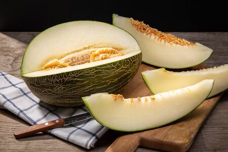 Fresh Muskmelon with slices on wooden table. Cucumis meloの写真素材
