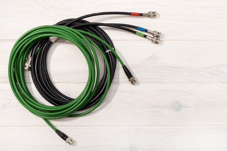 Communication background. Pro video cables on white wooden table. Copy space. Top view