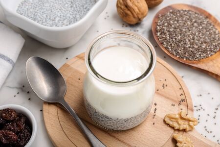 Yogurt and chia pudding in glass on table. Well being, weight loss, superfood, healthy eating conceptの写真素材