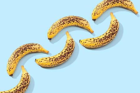 Spotted Banana pattern on blue background. Art food. Copy spaceの写真素材