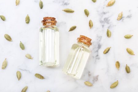 Cardamom essential oil on marble table. Elettaria cardamomum. Top viewの写真素材
