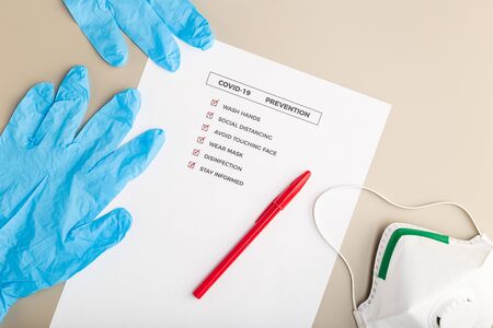 Coronavirus advice or prevention concept. Top view of a COVID-19 prevention check list and safety equipmentの写真素材