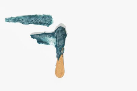 Hot wax depilation concept. Hot wax strip texture and spatula isolated on white background. Hair removal waxing conceptの写真素材