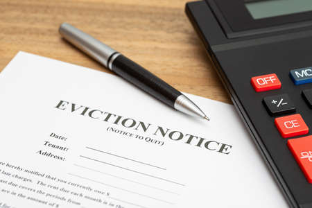 Eviction Notice Document and calculator on the deskの写真素材