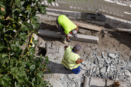 Construction workers working on sidewalk. City Maintenance concept
