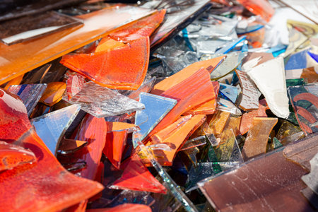 Random pieces of broken glass. Garbage of Colored glass pieces mixed. Background texture