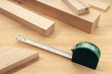 Group of assorted Wood material with a measure tape. Carpentry timber material measure or woodwork concept. Close upの写真素材