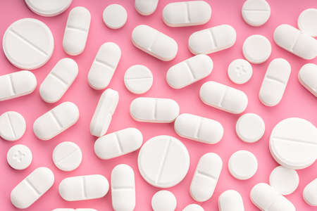 Medicine pills on pink background. Top viewの写真素材