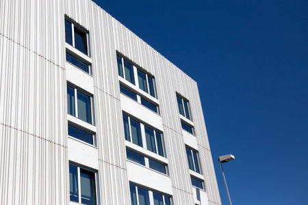 Modern apartment building with decorative grooved concrete facade. Copy space