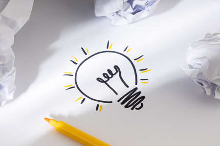 Bright Idea Concept. Hand Drawn Light Bulb On Paper and crumpled paper around. Creative process conceptの写真素材