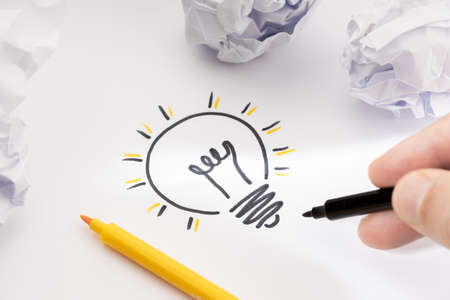 Bright Idea Concept. Hand Drawing Light Bulb On Paper and crumpled paper around. Creative process conceptの写真素材