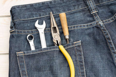 Set of tools in in jeans pocket. Labor day background conceptの写真素材