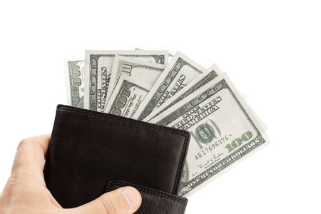 Hand holding a Leather wallet with money isolated on white background. US dollar bills