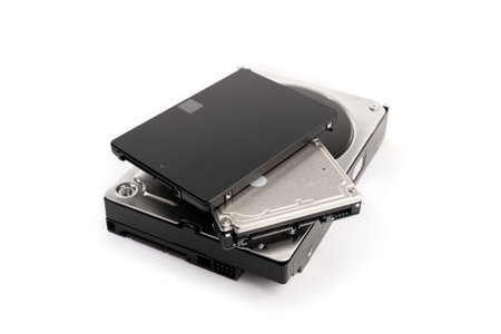 Pile of a variety of computer Hard disk drive HDD and SSD isolated on white background. Computer...