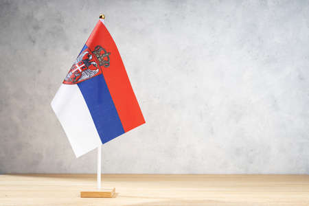Serbia table flag on white textured wall. Copy space for text, designs or drawingsの写真素材