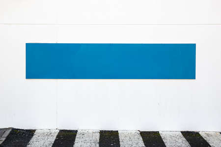 Blank blue sign placed on white wall on the outside of building. Template mock upの写真素材