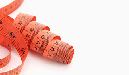Red Measuring tape isolated on white background. Copy spaceの写真素材