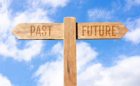Past or future concept. Wooden signpost with message on sky backgroundの写真素材