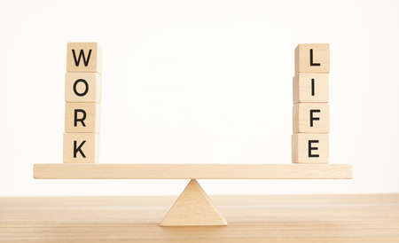 Balance Between Life And Work concept. Wooden blocks with word on Seesaw. Copy spaceの写真素材