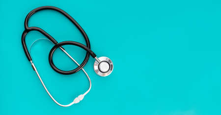 Health care medical background banner. Flat lay of stethoscope on green background. Copy spaceの写真素材