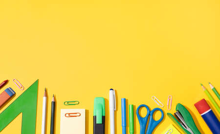 Back to school background with copy space. Variety of Office and school supplies on yellow backgroundの写真素材
