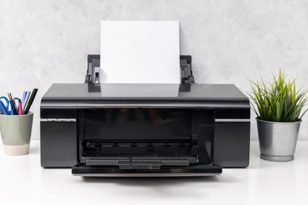 Inkjet printer with blank paper sheet on office desk. Template mock up