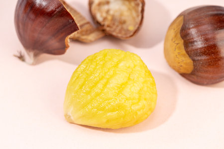 Peeled sweet chestnut on pink background. Castanea sativaの写真素材