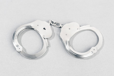 Handcuffs isolated on gray background