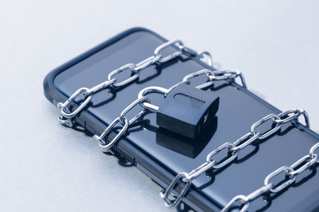 Phone security and data privacy concept. Smartphone locked with chain and padlockの写真素材