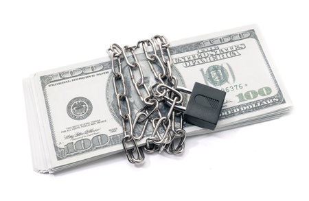 Lock security and chain on dollar stack banknotes isolated on white background. Monetary crisis, financial problems, default conceptの写真素材