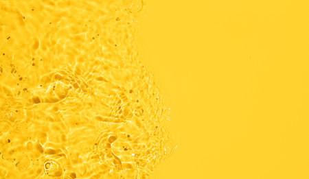 Banner of Yellow Abstract water background texture with ripples and waves. Copy spaceの写真素材