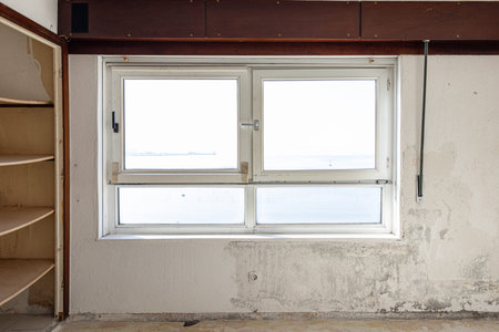 Interior view of a damaged window in an aged room ready to be renovated. Home improvement concept