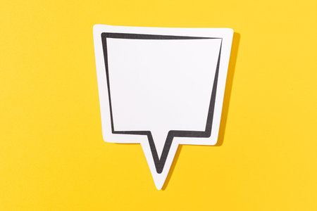 Blank Speech Bubble isolated on yellow background. Mock up templateの写真素材
