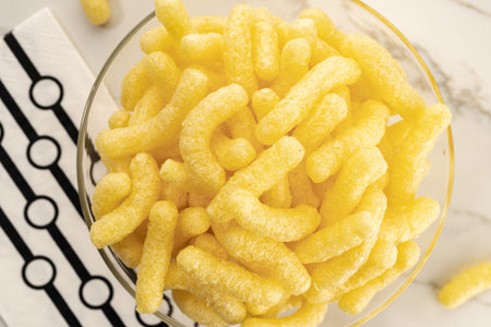 Corn sticks in bowl on table still life. Top view