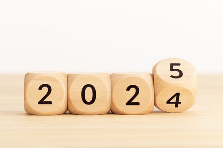 Wooden Blocks with changing numbers 2024 to 2025. New year concept. Copy space. White background