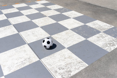 Soccer ball isolated on a gray and white checkered backgroundの写真素材