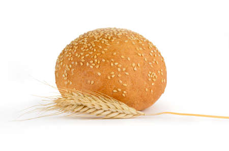 Fresh bread with sesame seeds and spikelets on a white backgroundの写真素材