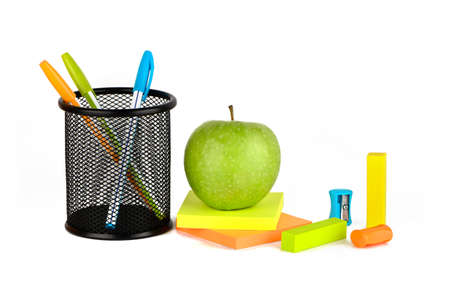 Multicolored stationery set with a green apple on a white backgroundの写真素材