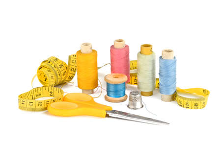 Thread, scissors, inch and a thimble on a white backgroundの写真素材