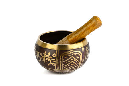 Singing bowl with mallet on a white backgroundの写真素材