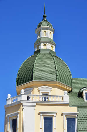 The architectural structure with a green dome on a background of blue skyの写真素材