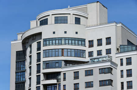 Light, gray, a large building on a background of blue skyの写真素材