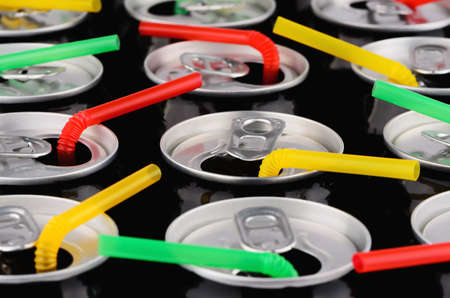 aluminum cans with colorful strawsの写真素材
