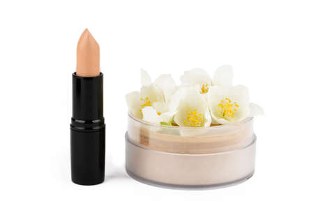 Brown lipstick and powder on a white background with jasmine flowersの写真素材