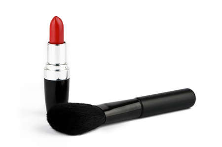 Red lipstick and fluffy powder brush on a white backgroundの写真素材