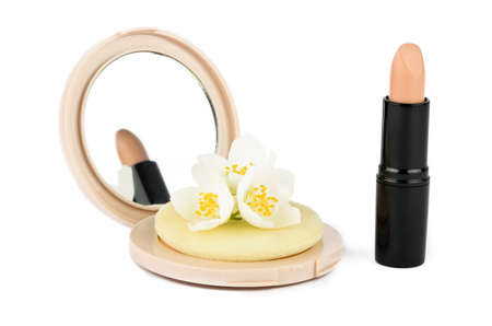 Powder and lipstick on a white background with jasmine flowersの写真素材