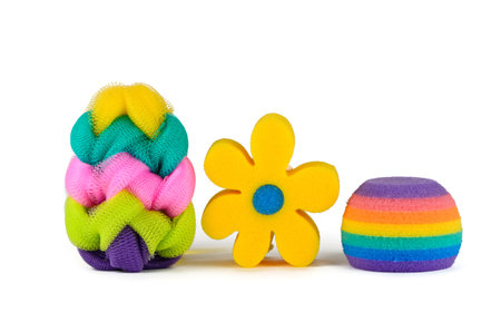 Three colorful sponges in a row on a white backgroundの写真素材